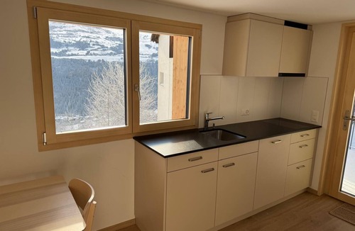 Andiast Apartment | Beautiful, modern studio with underfloor heating, kitchen, shower/WC and seating area.
