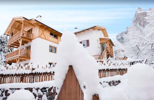 Siusi Villa | Chalet Baita, is seen at the foot of Seiser