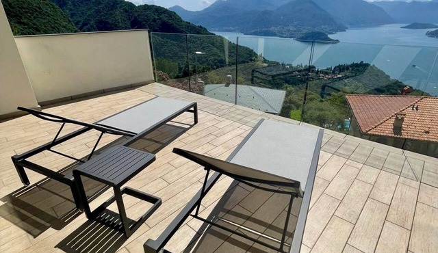 In a panoramic position, modern apartment on the first floor of a new residence with SPA. Large windows frame the unique landscape of Lake COMO.This apartment has a beautiful terrace, with table and chairs and a sofa. The living room is a large open spac in Perledo