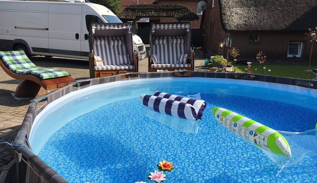 Relax under thatch with pool, beach chairs and loungers in Belum